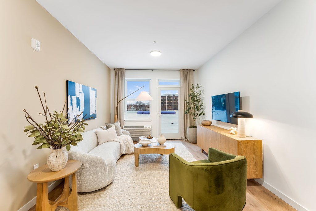 A Living Room With a Green Chair at Hue Soul Apartments, East Orange, NJ