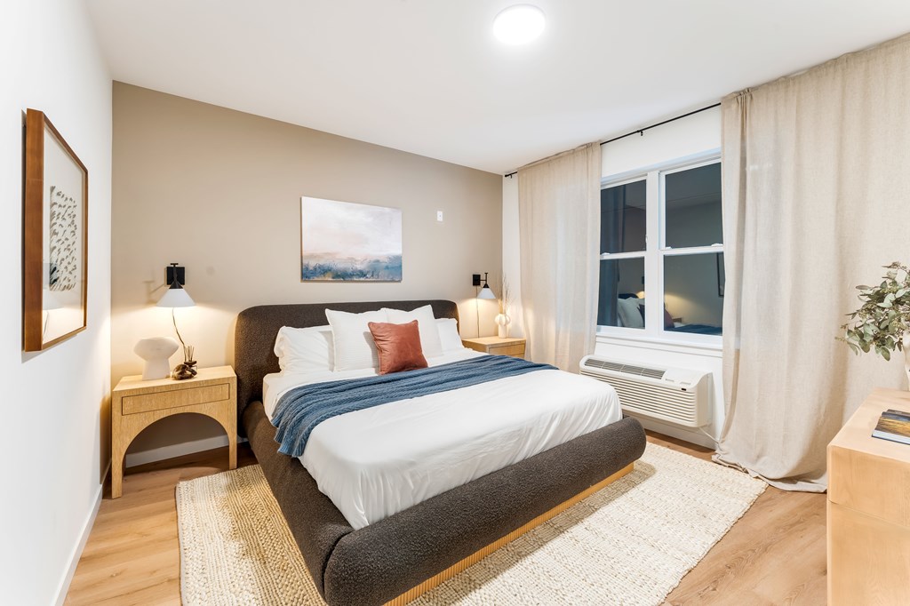 A Bedroom With White Curtains at Hue Soul Apartments, East Orange