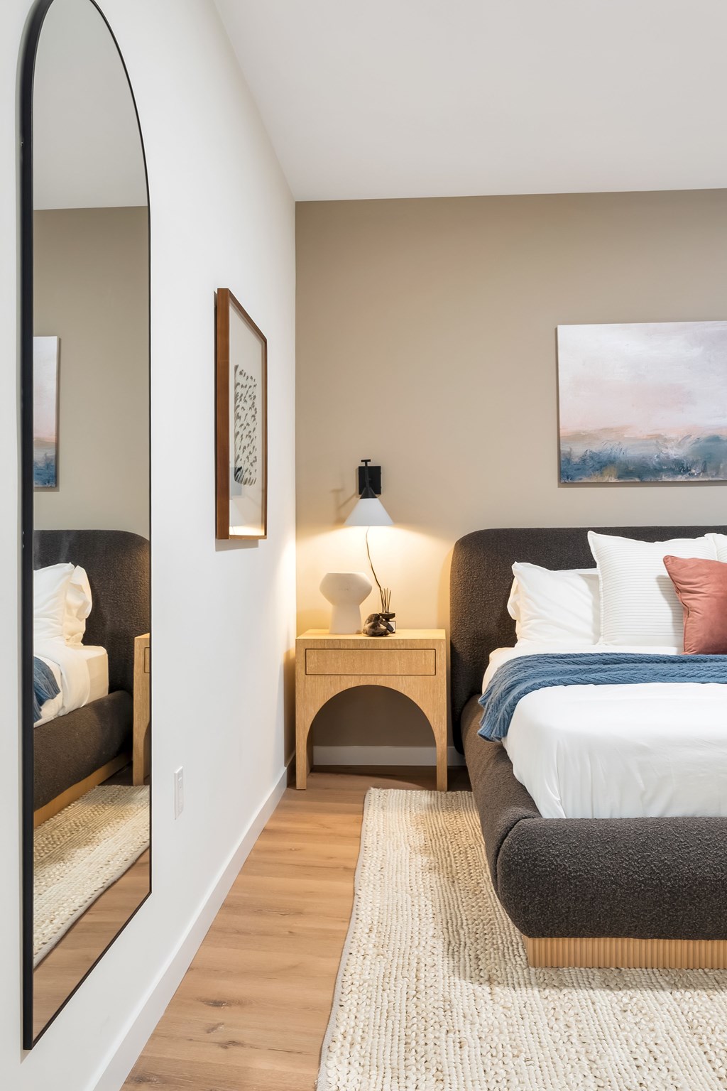 A Bedroom With a Full Size Mirror at Hue Soul Apartments, East Orange