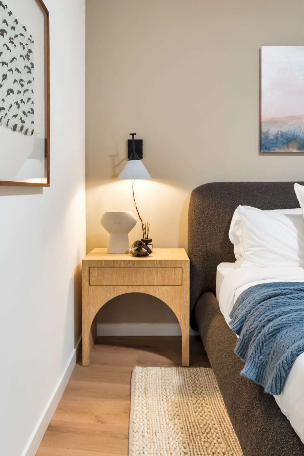 A Bedroom With a Nightstand and Lamp at Hue Soul Apartments, New Jersey, 07018