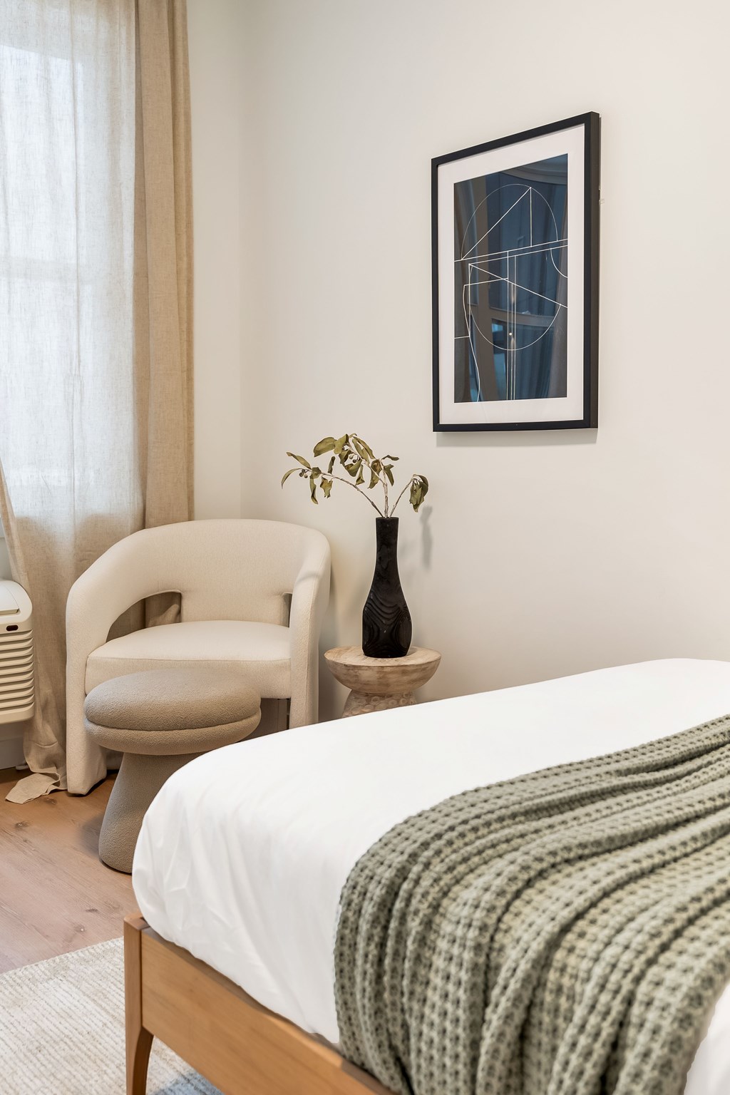 A Bedroom With a Chair at Hue Soul Apartments, New Jersey