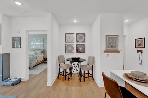 Open dining nook with small table and decorative wall art at 34 Eden Lane Apartments, New Jersey, 7981