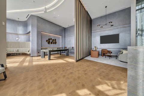 A modern living room with a wooden floor and a grey wall.