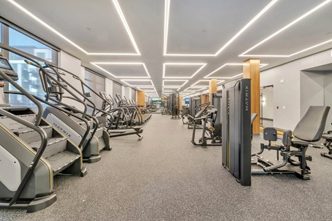 A gym with treadmills, exercise bikes, and other equipment.