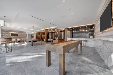 A modern dining room with a large wooden table and chairs.
