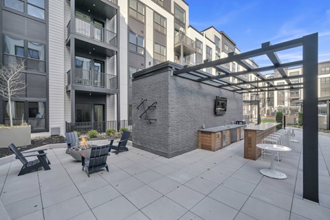 A patio area with a bar and seating area.
