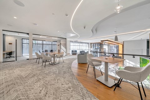 A modern dining room with a large table and chairs.