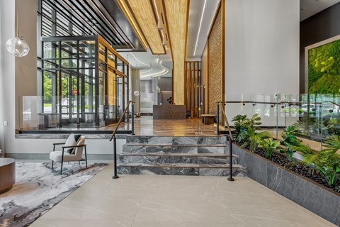 A modern interior with a wooden ceiling beam and a glass wall.