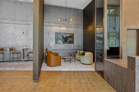 A modern living room with a wooden floor and a large painting on the wall.