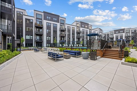 A sunny day at a modern apartment complex with a spacious courtyard.