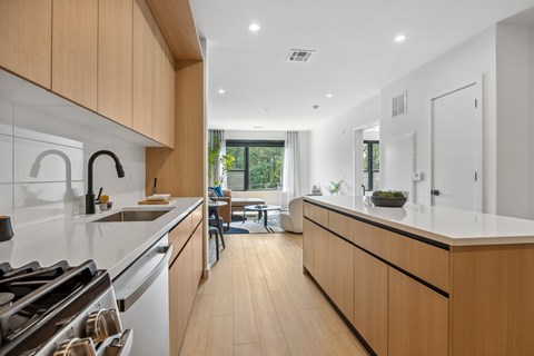 A modern kitchen with wooden cabinets and white appliances.