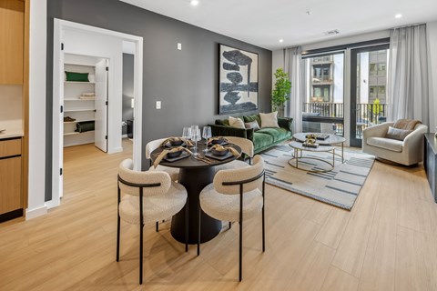 A modern living room with a black table and chairs.