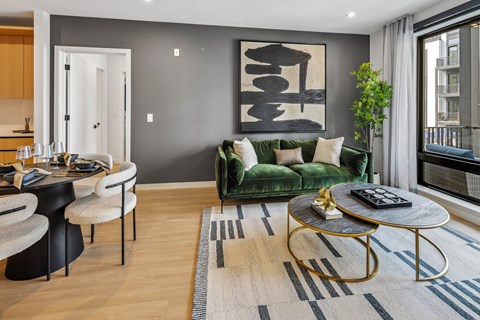 A living room with a green couch and a coffee table.