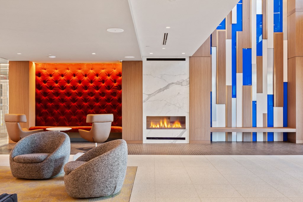 the lobby of a hotel with a fireplace and chairs