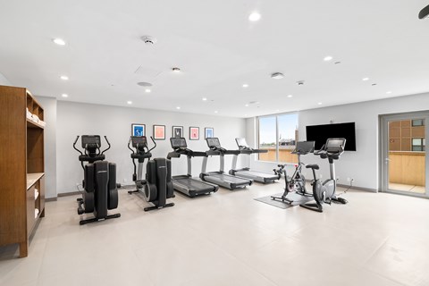 A spacious gym with a variety of exercise equipment.