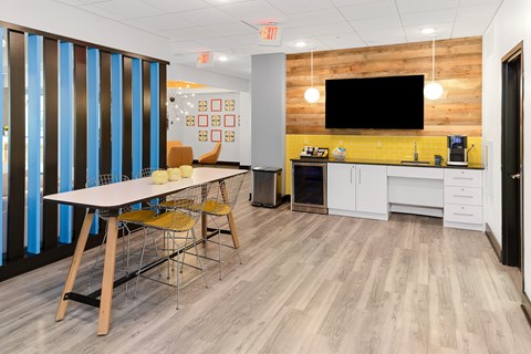 A room with a wooden table and chairs.
