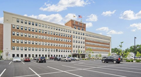 A large building with a parking lot in front of it.