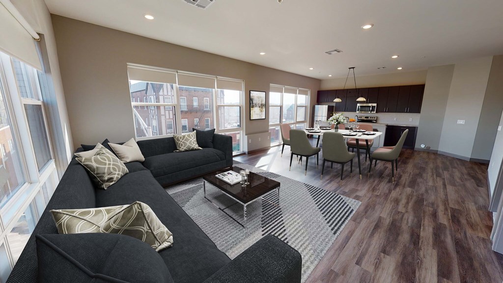 A living room with a black couch and a coffee table at Crossroads 389 Apartments, Hackensack, New Jersey