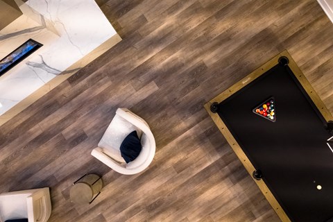 A pool table with a triangle in the middle is in the center of the image.