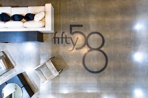 A modern interior space with a sofa, coffee table, and a wall with the number 58.
