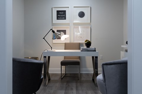 A white desk with a lamp and a vase on it.
