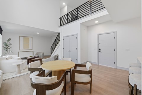 A modern living room with a wooden table and chairs.