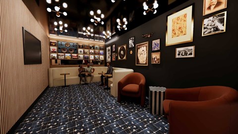 A room with a blue carpet and a black wall with pictures.
