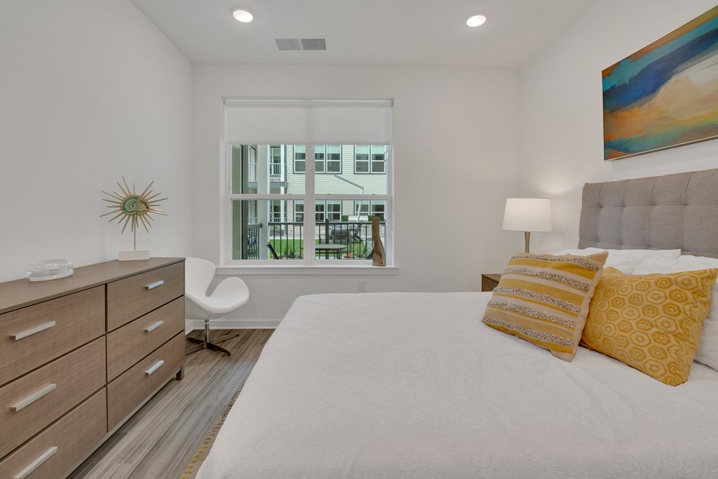 a bedroom with a large bed and a window