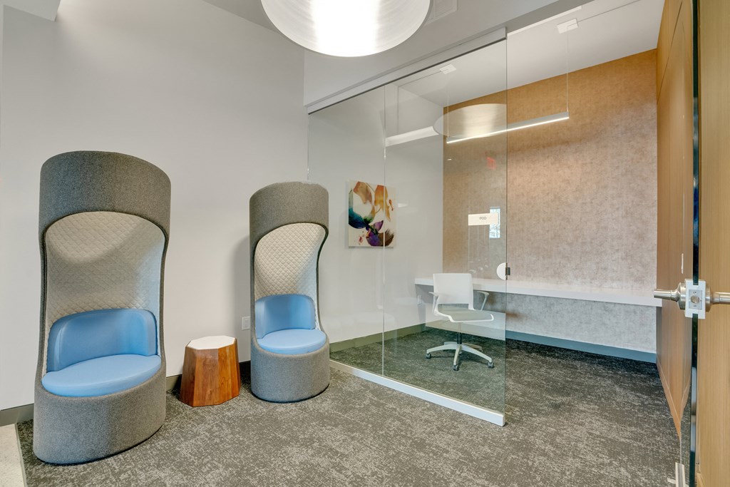 a meeting room with two chairs and a glass shower