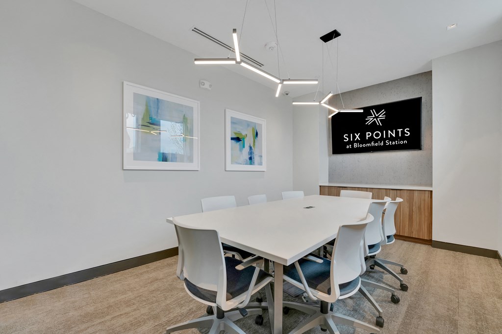 a conference room with a white table and chairs