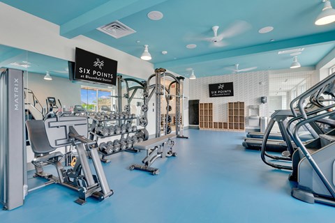a fitness room with weights and cardio equipment at six points