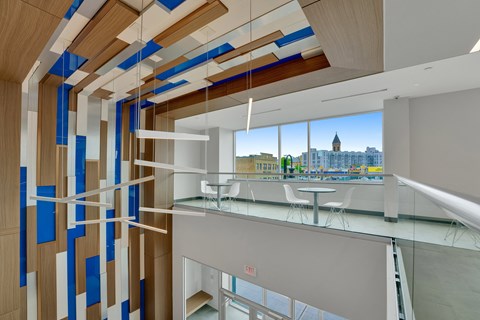 the lobby of a building with a glass railing and a view of the city
