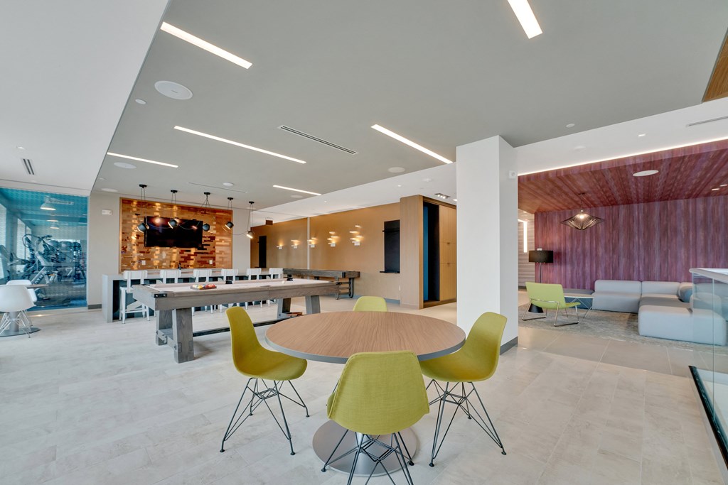 a large lobby with a table and chairs and a tv