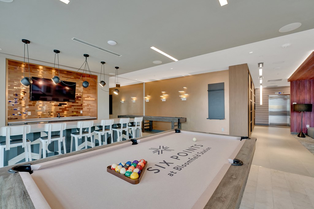 a game room with a pool table and a scoreboard