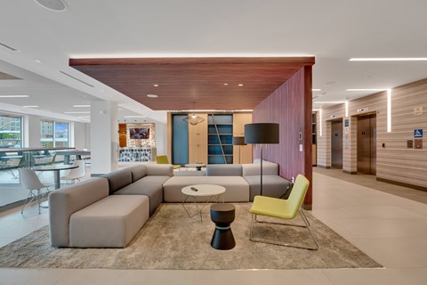 a living room with a gray couch and a yellow chair