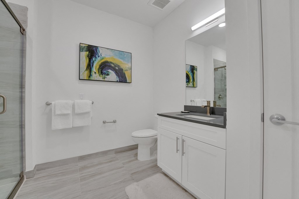 a bathroom with a sink and a toilet and a shower