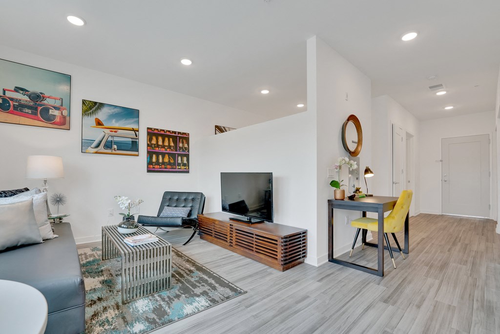 a living room with a couch and a table with a television