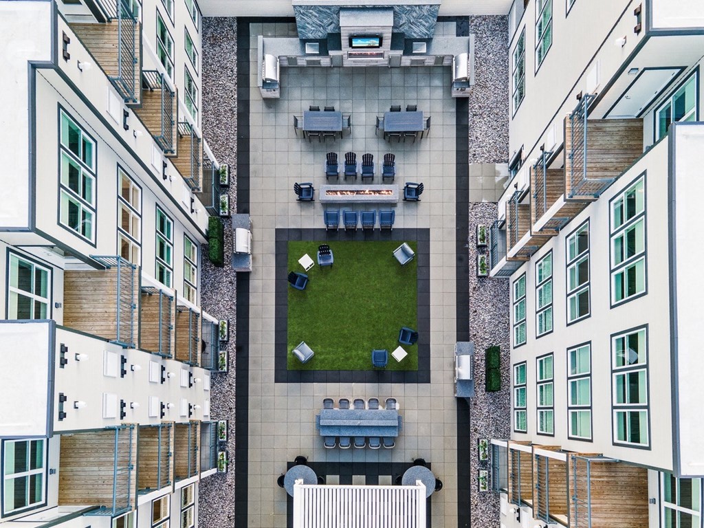 an aerial view of the courtyard of a building with tables and chairs