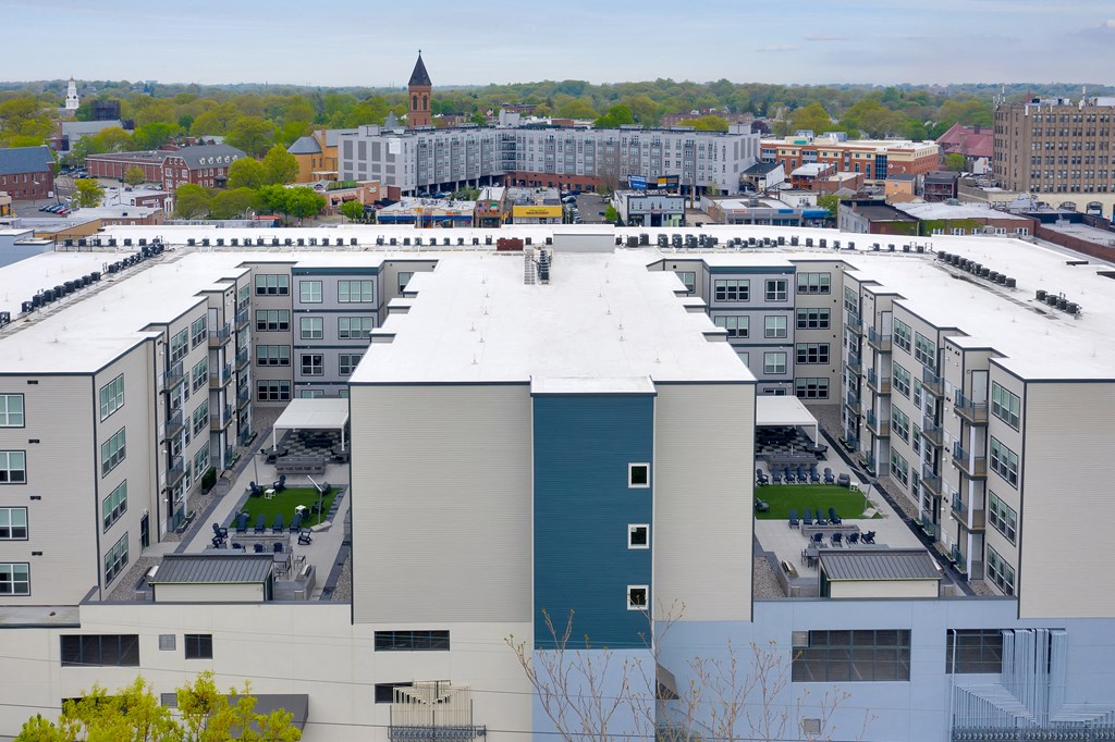 an aerial view of a large building with a white roof