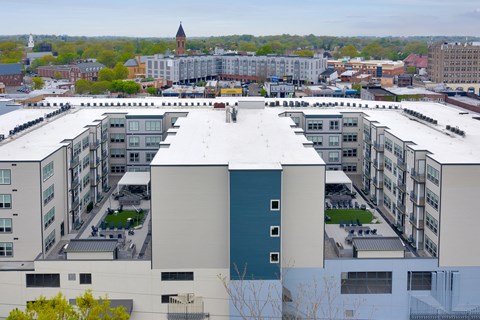 an aerial view of a large building with a white roof