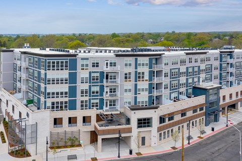 an aerial view of a large apartment building with many windows and a parking lot