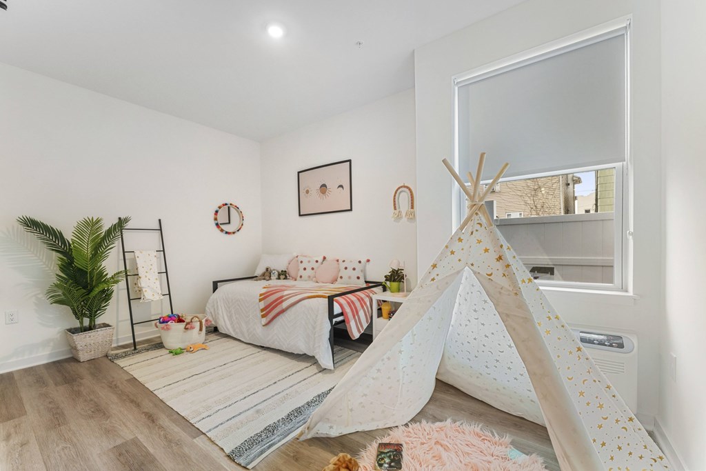 A room with a bed and a teepee tent.