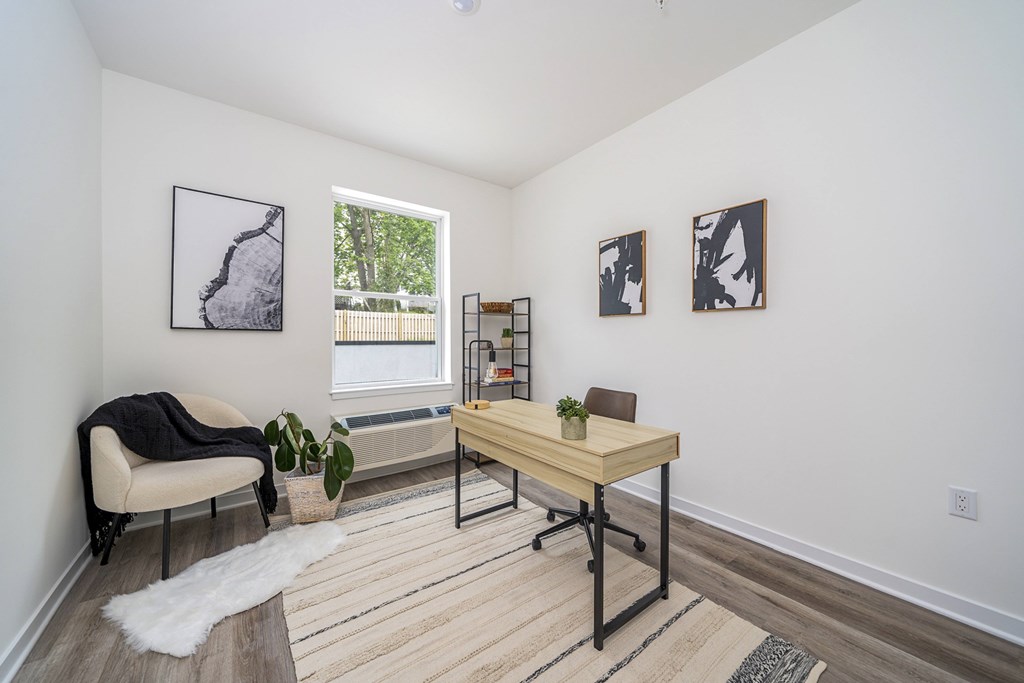 A room with a table, chairs, and pictures on the wall.
