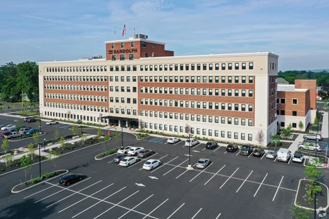 A large building with a parking lot in front of it.