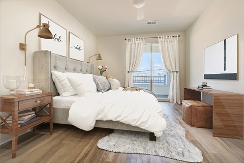 A bedroom with a large bed and a window with curtains.