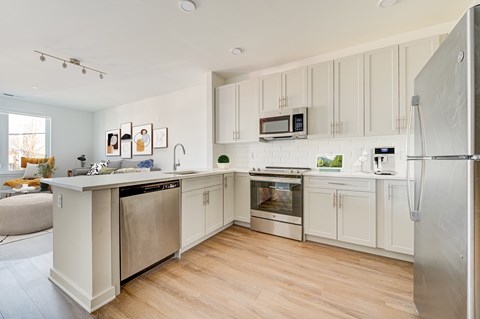 A kitchen with white cabinets and stainless steel appliances.