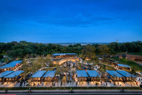 A large building complex with a lot of people walking around.