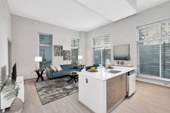 Kitchen island with built-in sink and Italian cabinetry in select apartment homes Apartments for rent in Crystal City - Photo Gallery 3