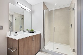 Quartz countertops and Italian style vanity in bathrooms with glass shower in select apartment homes Apartments for rent in Crystal City - Photo Gallery 5