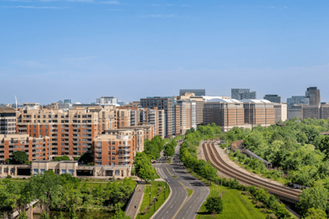 A curvy road with a green grassy area on the side.